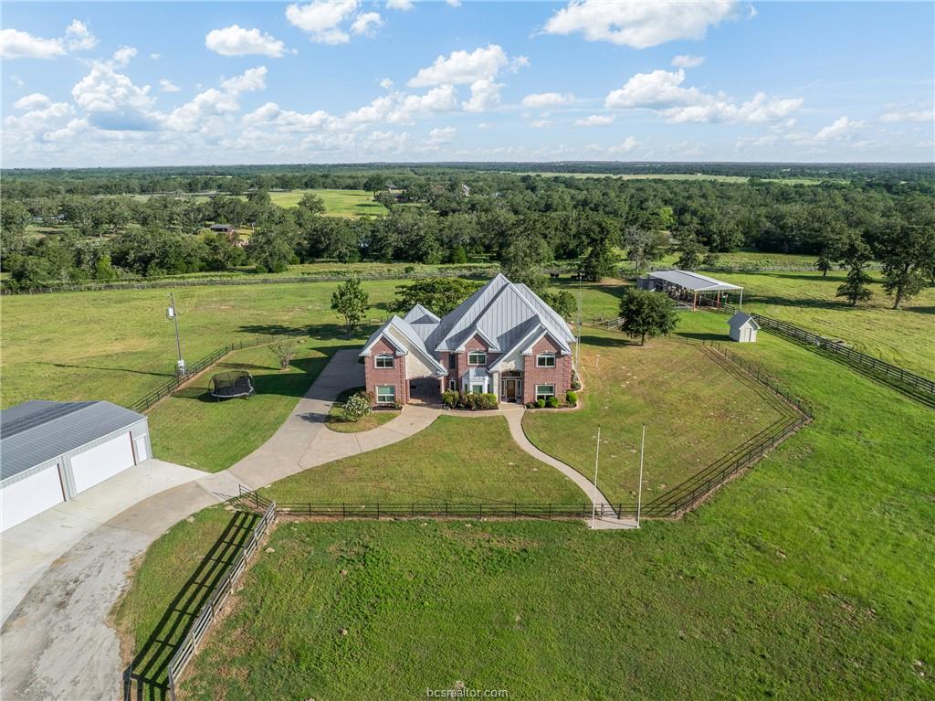 Aerial view of the ranch house and fenced grounds at 4845 County Road 119 near Caldwell, Texas