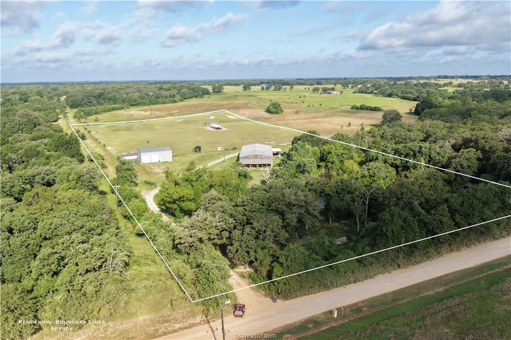 Aerial view of the barndominium, shop, pond, and acreage at 6128 County Road 358 near Gause, Texas
