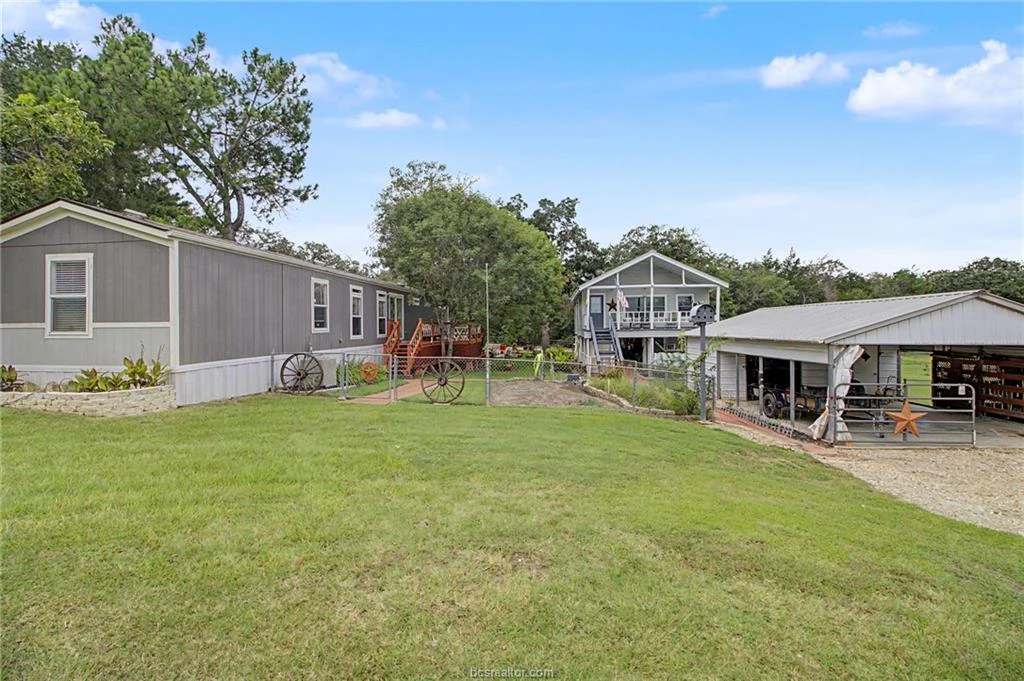 Two homes, a covered storage structure, and landscaped grounds at 637 Lakeview Drive in Caldwell, Texas
